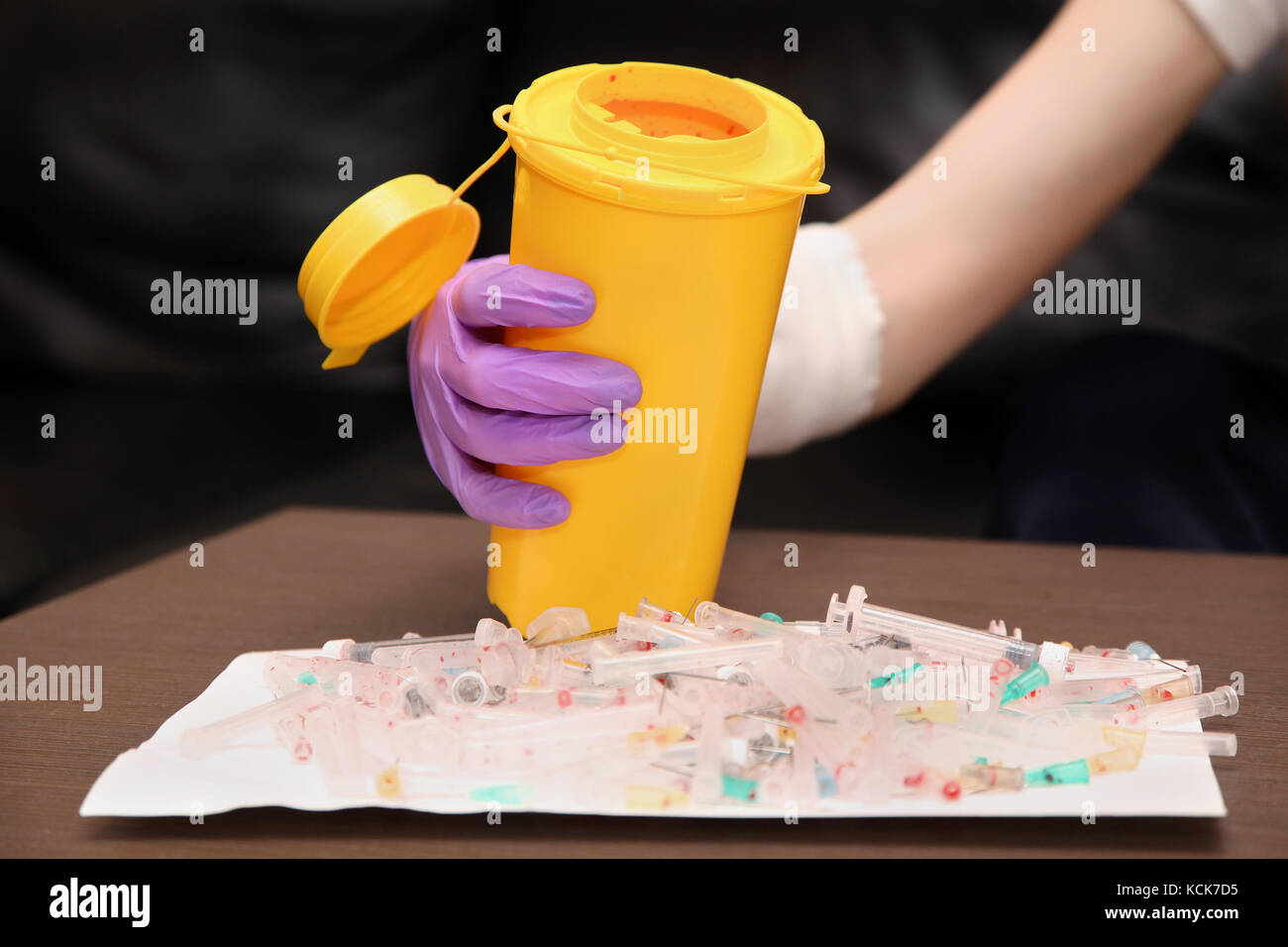 Medical waste with used syringes and needles put into disposable