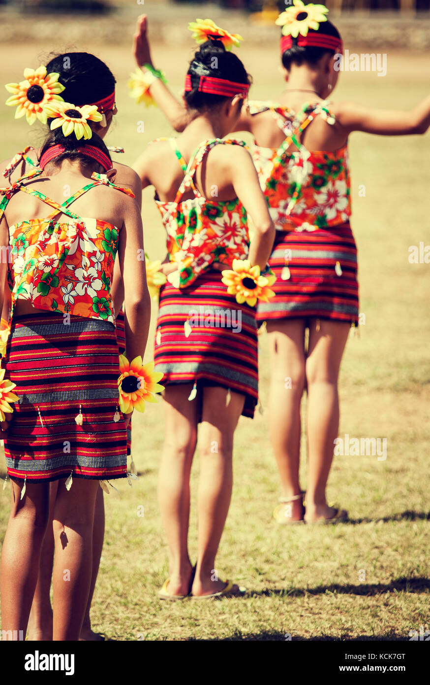 Filipino girls prepare to dance at the Panagbenga Festival (Blooming Flowers Festival) or the Baguio Flower Festival in colorful tribal costume Stock Photo