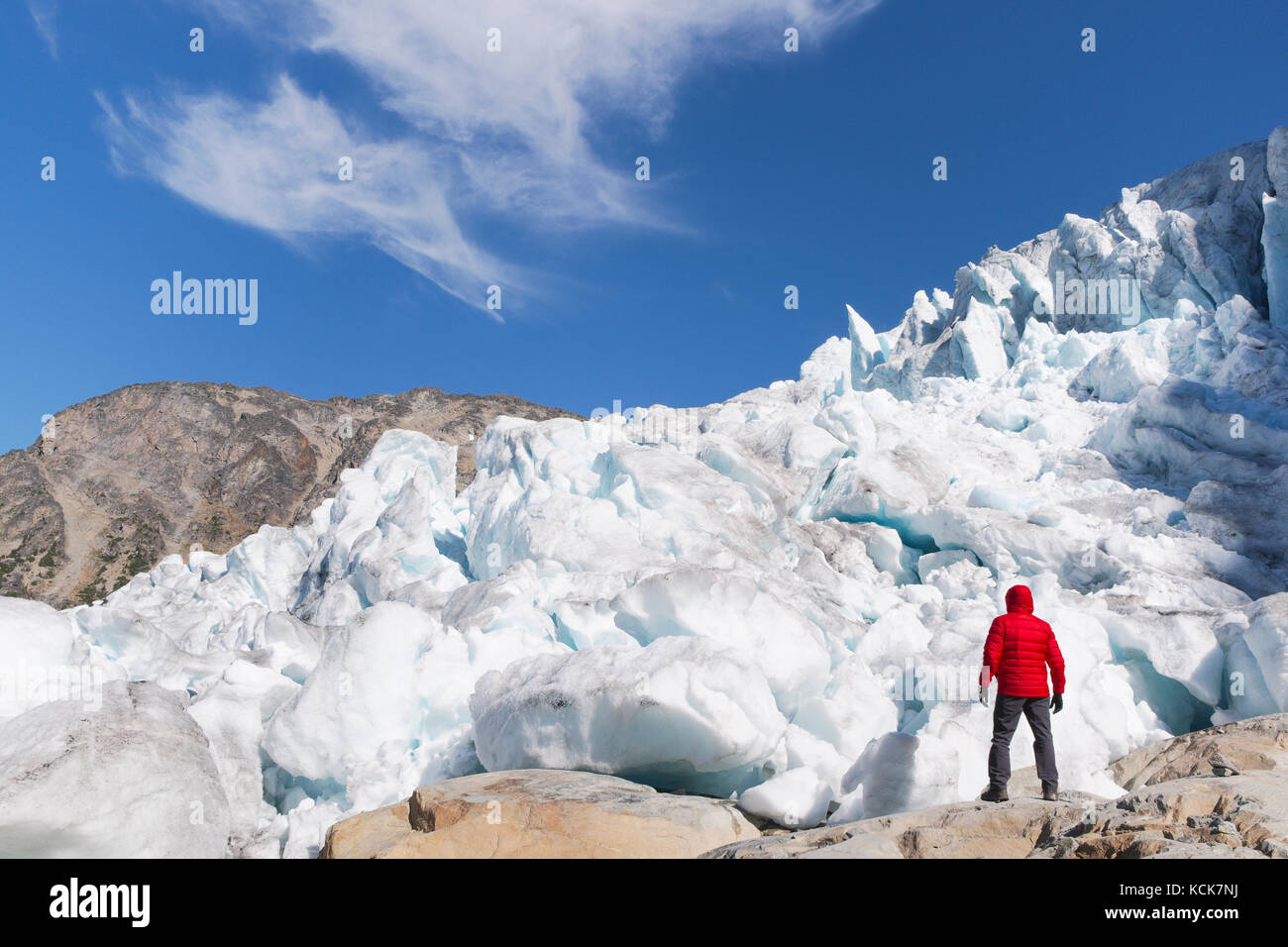 Hiker in front of Matier Glacier in Joffre Lakes provincial park, British Columbia, Canada. Stock Photo