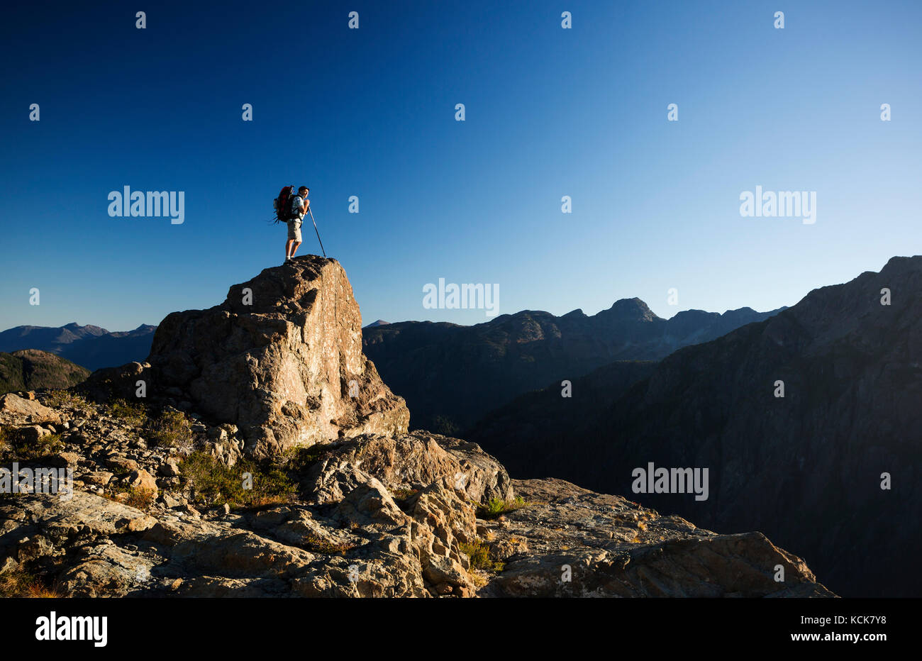A lone hiker on the Flower Ridge trail overlooks the Henshaw/Shepherd Creek watershed in Strathcona Park, Central Vancouver Island, British Columbia, Canada Stock Photo
