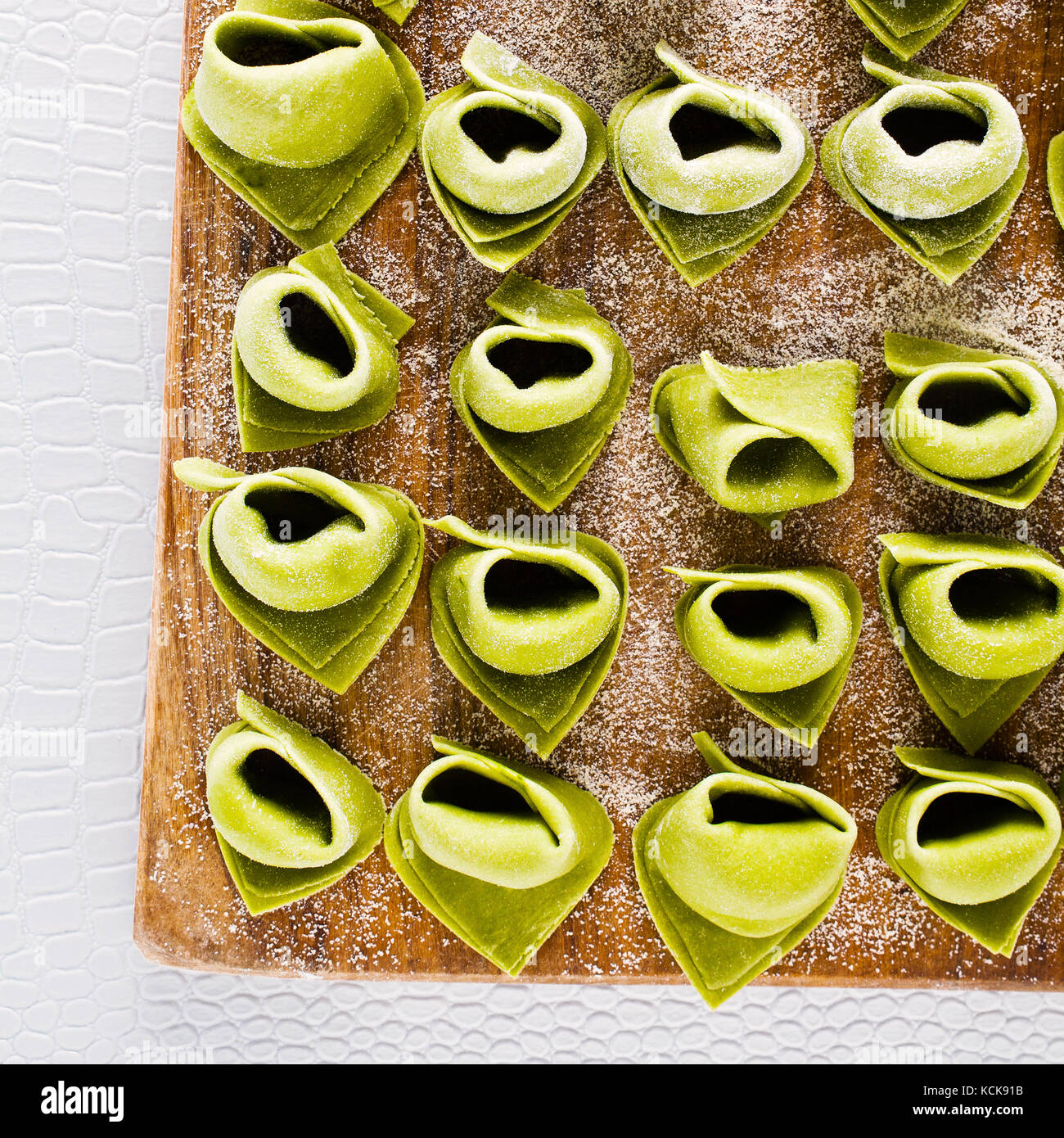 green tortellini with spinach and ricotta before boiling. raw filled
