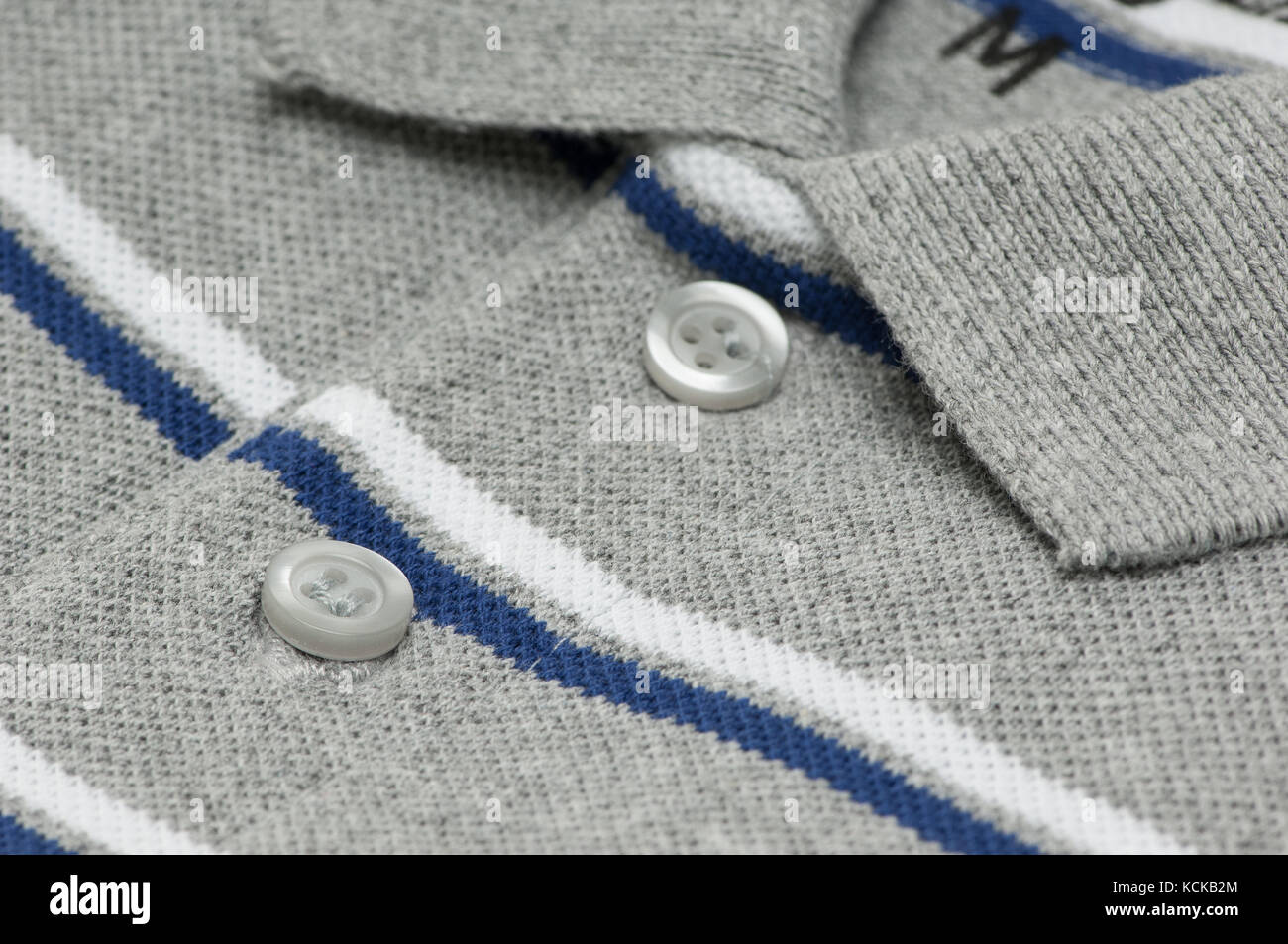 closeup tshirt grey color and collar and buttons. shirt grey with