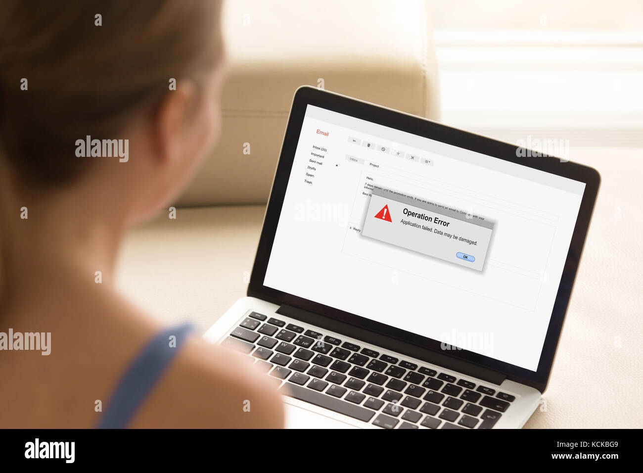 Young woman looks at laptop with Operation Error on laptop screen