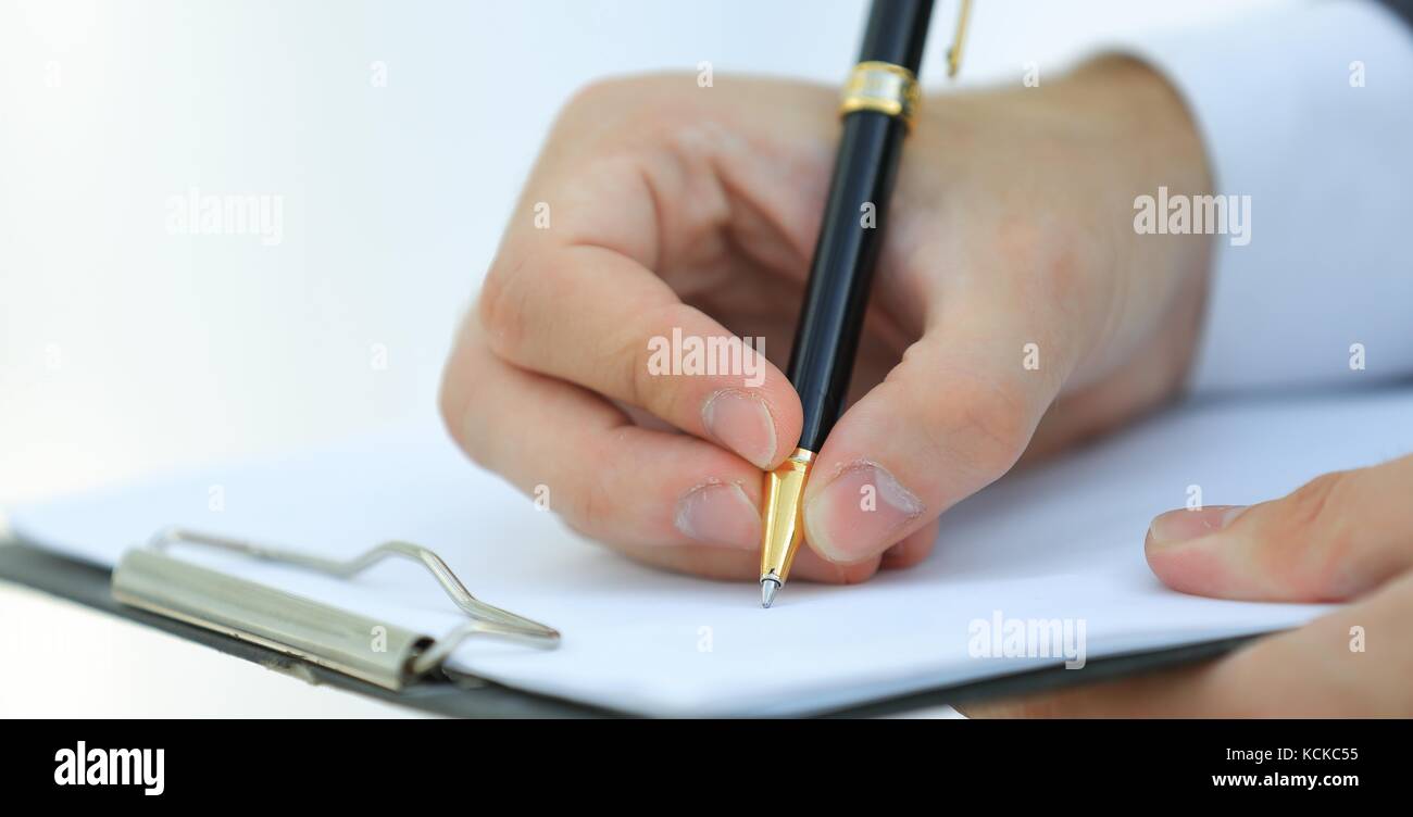 Businessman signs a contract. Holding pen in hand Stock Photo - Alamy