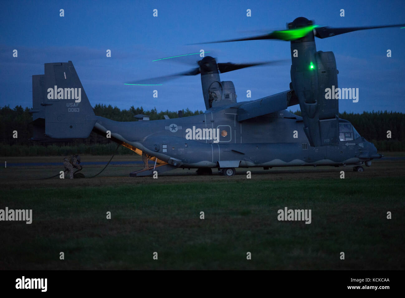 CV-22 Osprey crewman recovers the fast rope to prepare for the next ...
