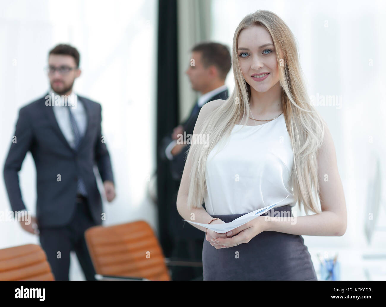 portrait of an elegant young business woman on the office background ...