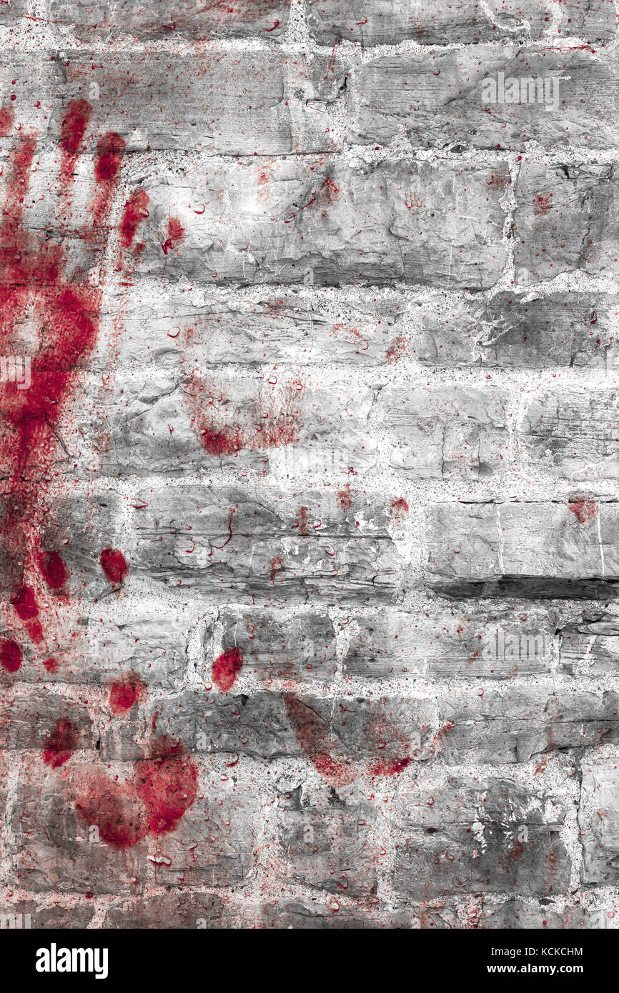 Bloody handprints and blotches of blood on grunge wall. Background for