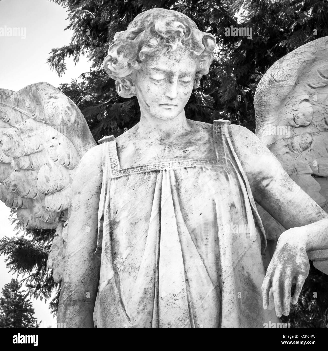 Vintage image of a sad angel on a cemetery as a symbol of love, kindness, and suffering Stock Photo