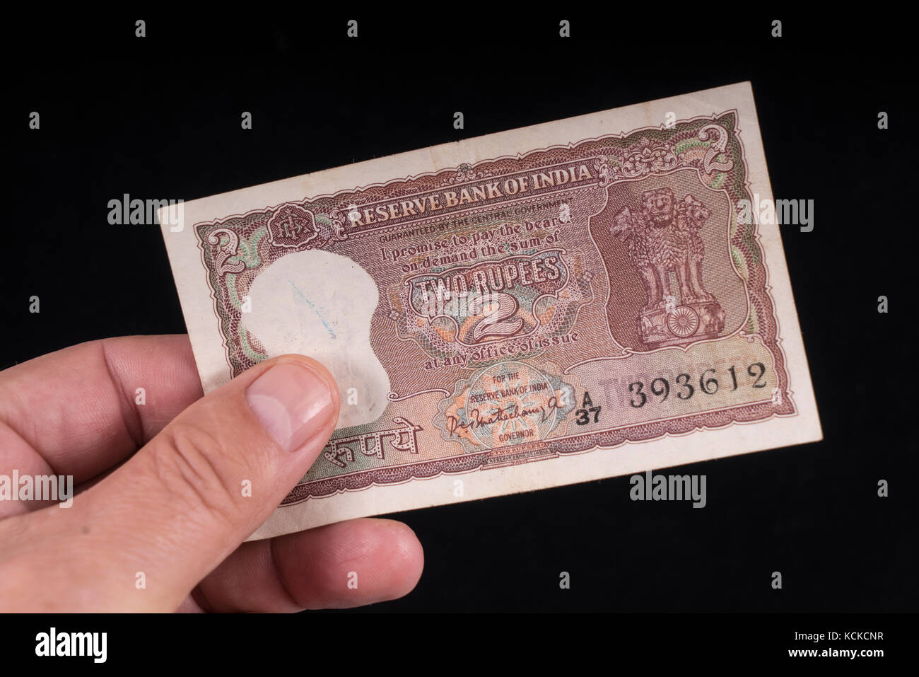 An old indian banknote on hand Stock Photo