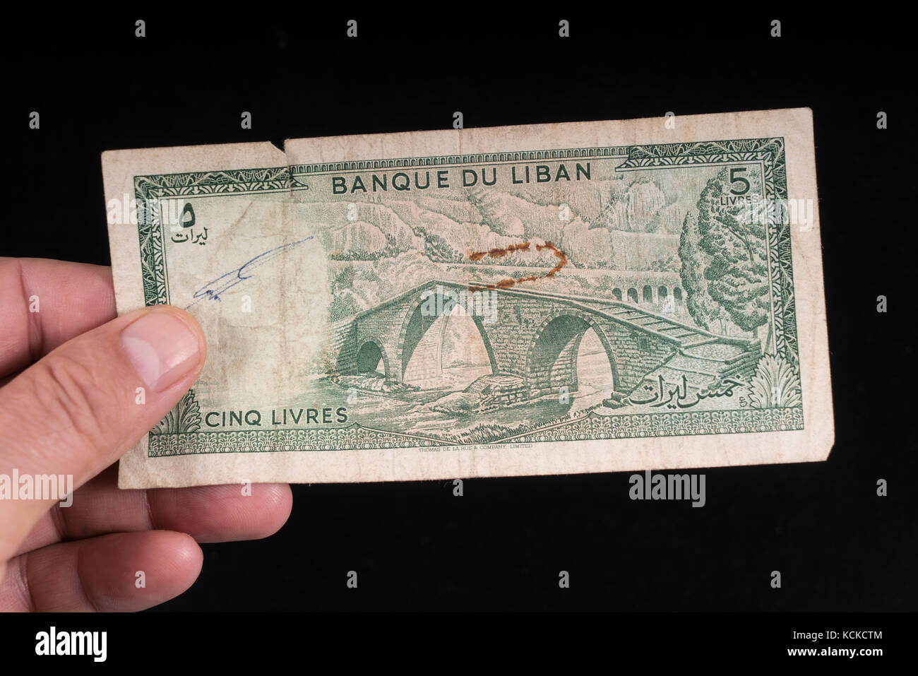 An old Lebanese banknote on hand Stock Photo