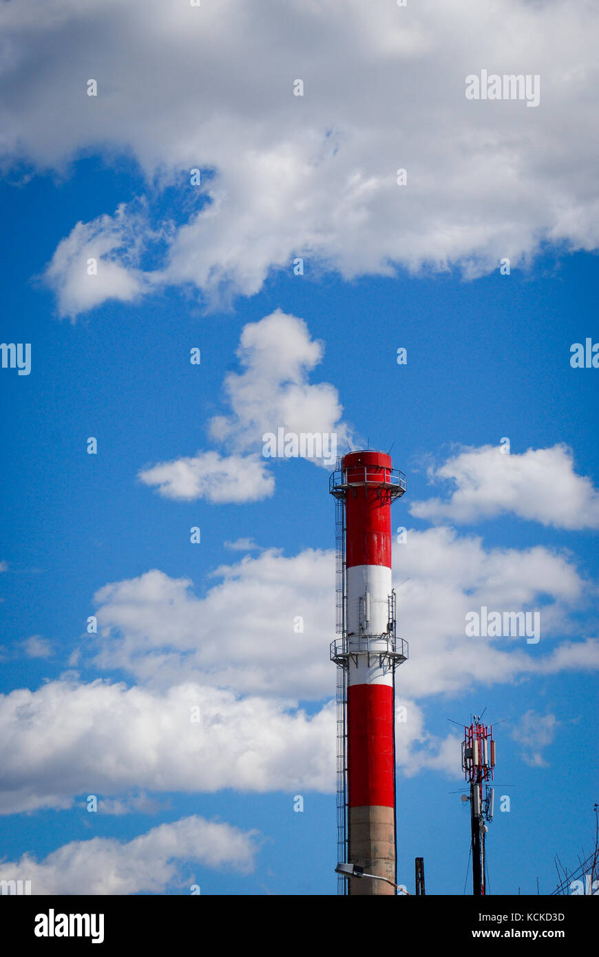 Heating chimney on blue sky with clouds and smoke Stock Photo - Alamy
