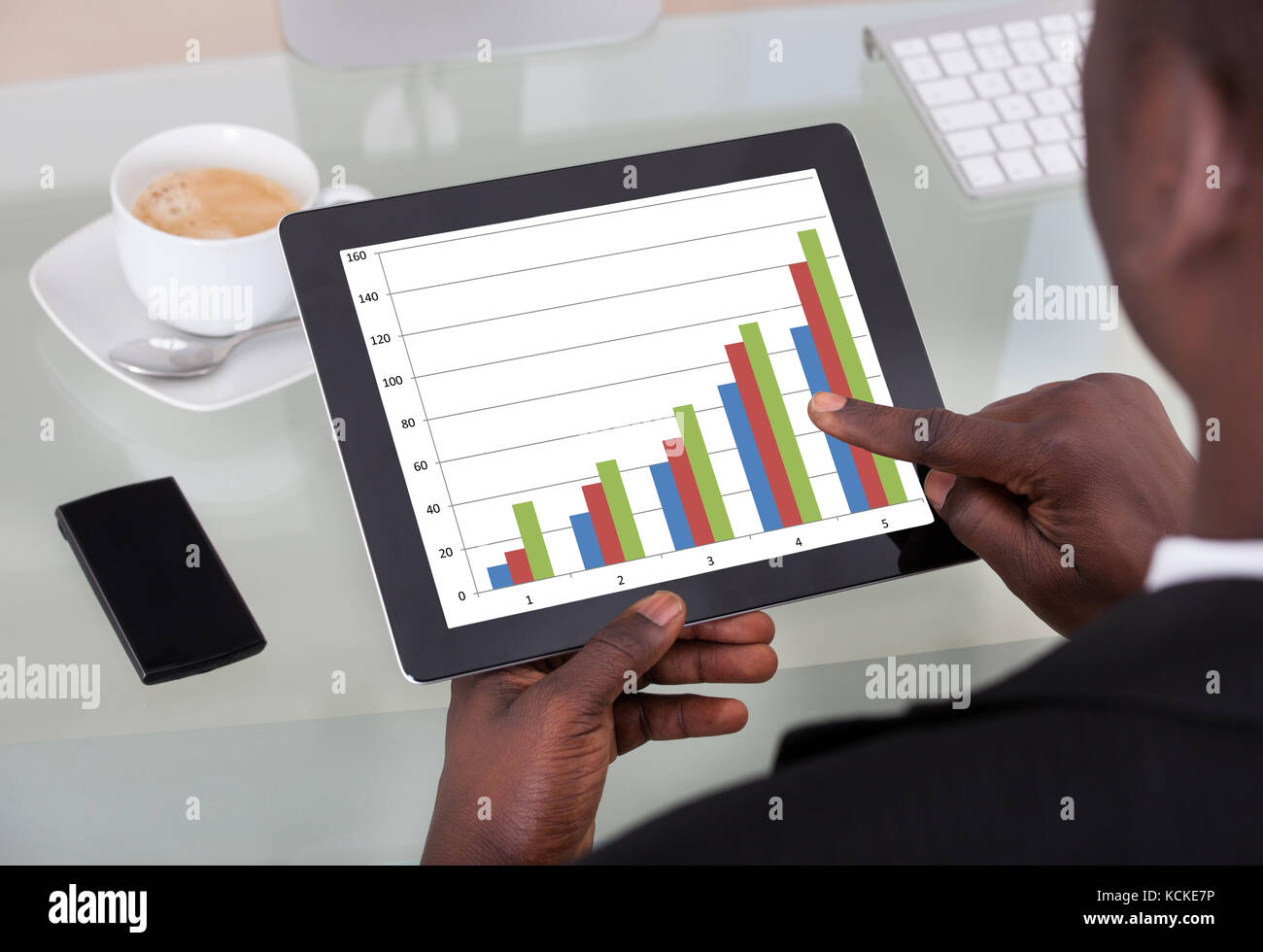 Close-up Of An African Businessman Analyzing Graph On Digital Tablet ...