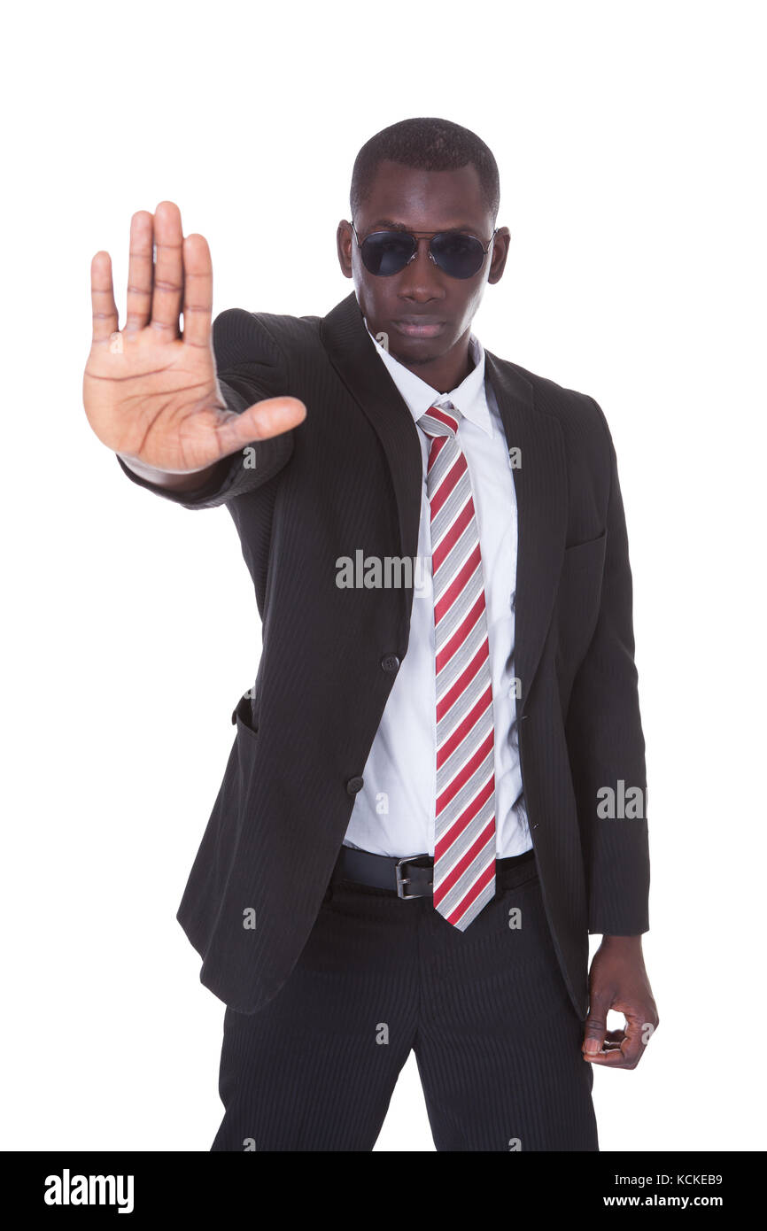 Portrait Of Young Businessman Wearing Sunglasses Gesturing Stop Sign