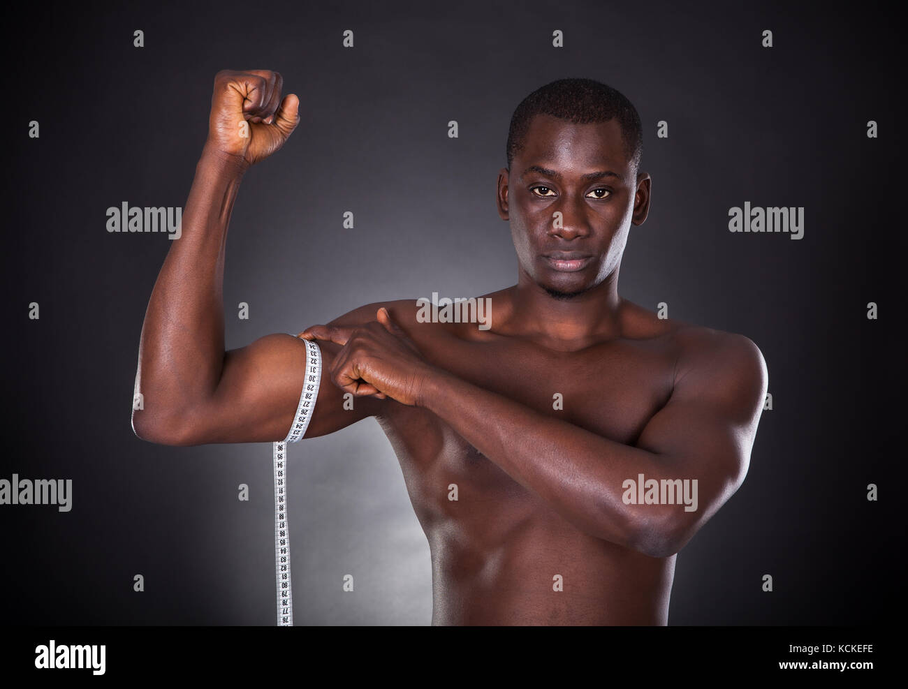 Man Measuring His Biceps With Measuring Tape On White Background Stock  Photo - Alamy