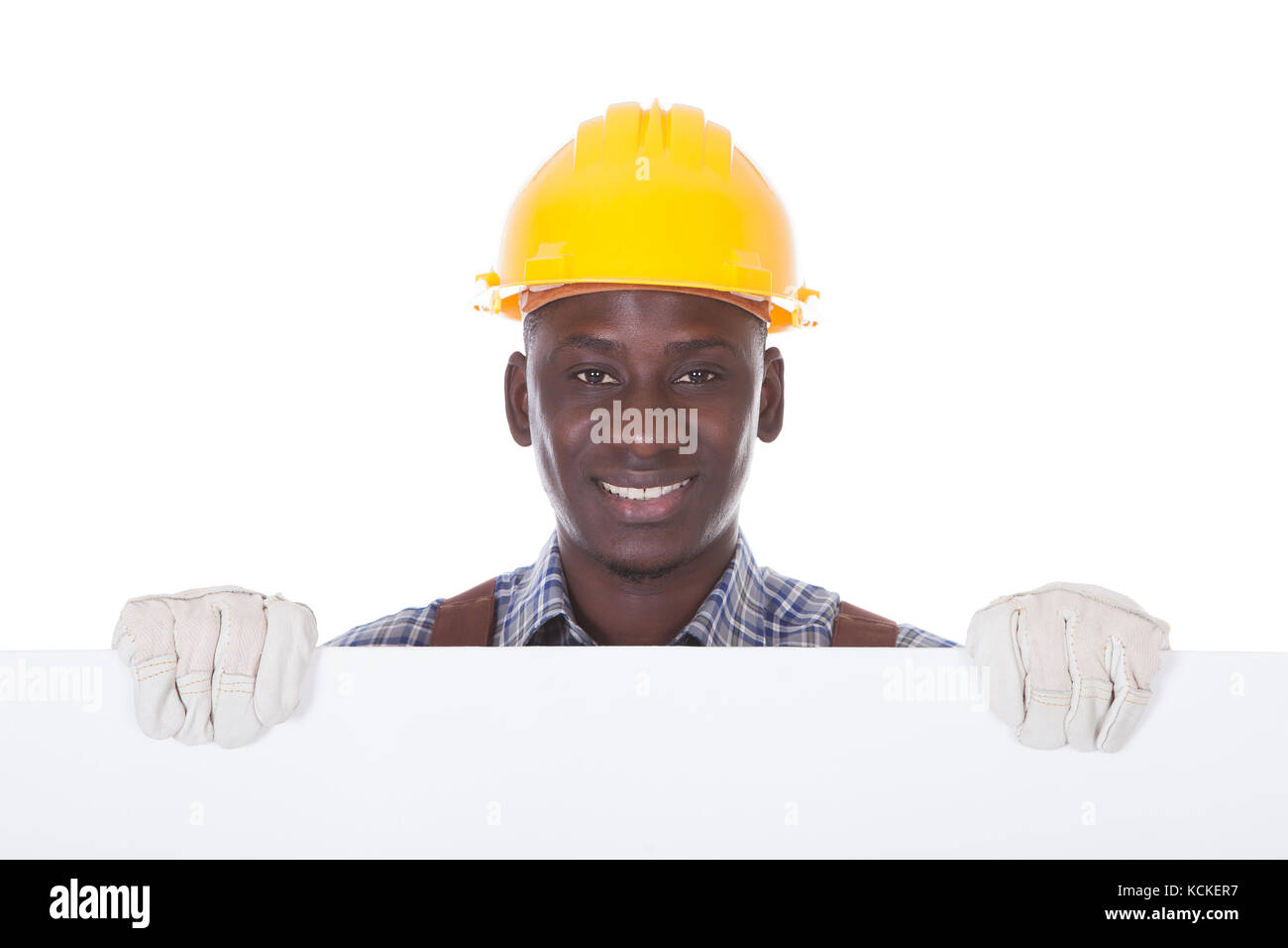 Young Repairman Holding Blank Bill Board Over White Background Stock Photo