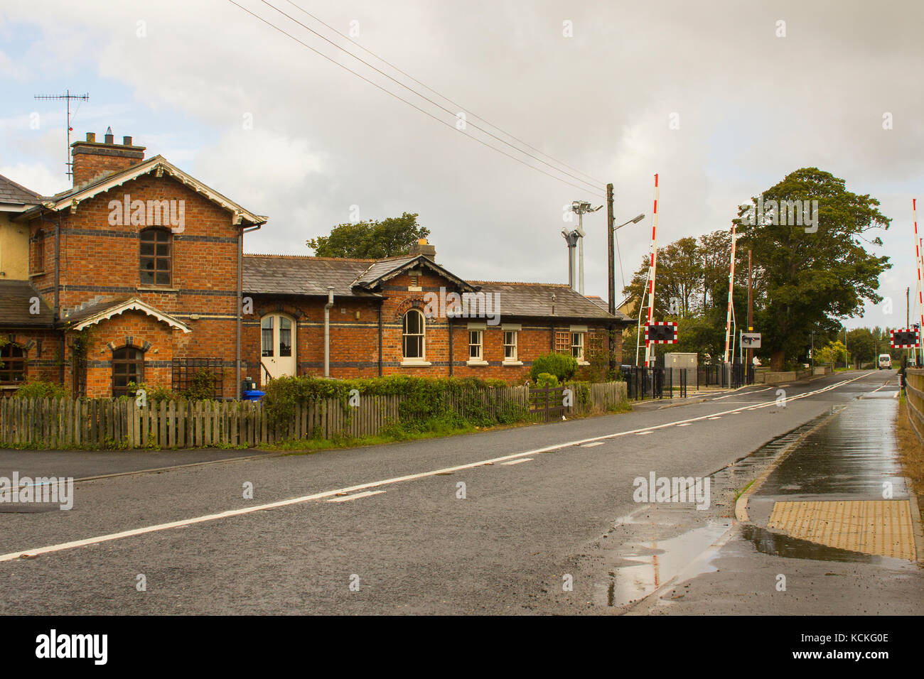 The refurbished station and automatic rail crossing at the town land of bellerena on the North coast of Ireland in County Londonderry on a dull day Stock Photo