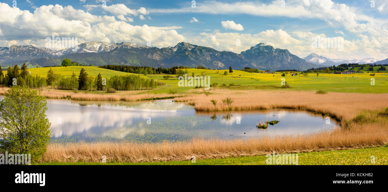 wide angle panorama landscape in Bavaria with lake and alps mountains Stock Photo