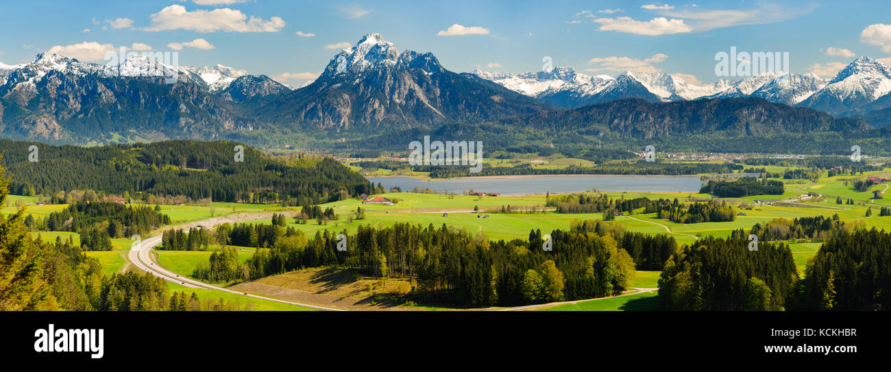 wide angle panorama landscape in Bavaria with lake and alps mountains Stock Photo