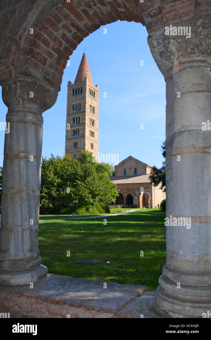 Pomposa abbey and bell tower, benedictine monastery in Codigoro, Ferrara, Italy. View from the archs of the Palazzo della Ragione building Stock Photo