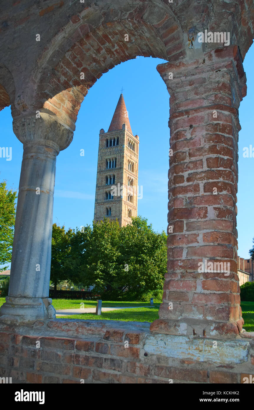Pomposa abbey and bell tower, benedictine monastery in Codigoro, Ferrara, Italy. View from the archs of the Palazzo della Ragione building Stock Photo