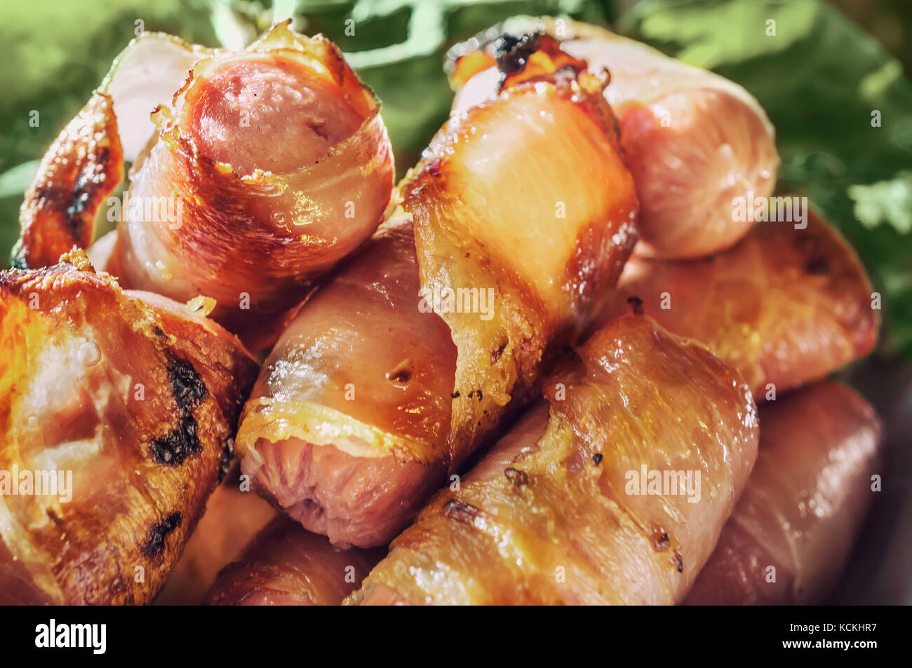 Sausages wrapped in bacon grilled on the barbecue. Closeup. Selective focus Stock Photo Alamy