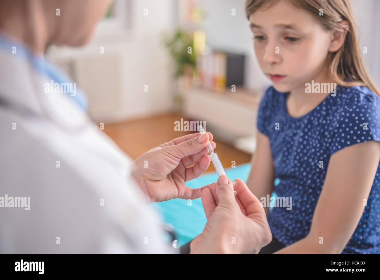 Pediatrics female doctor preparing a vaccine to inject into a patient Stock Photo