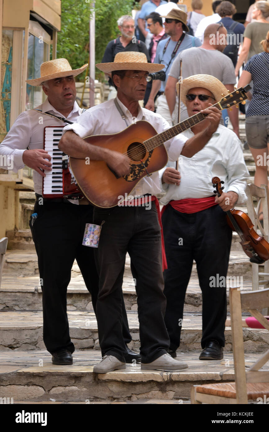 street musicians in Kerkira, Corfu, Greece playing guitars, piano  accordians and singing wearing hats in traditional costumes for the  tourists Stock Photo - Alamy