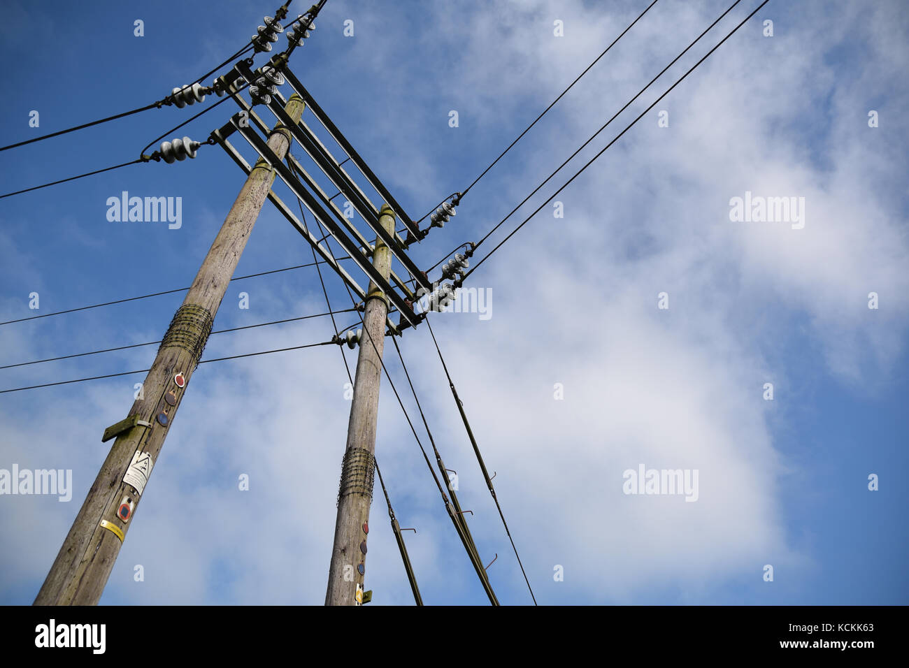 Electrical power lines on blue cloudy sky background Stock Photo - Alamy