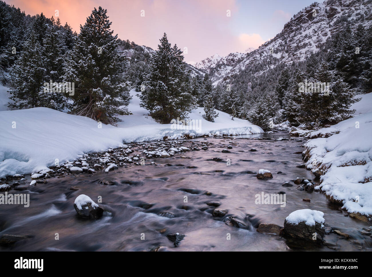 Sunrise on a snowy river of Ordino Stock Photo