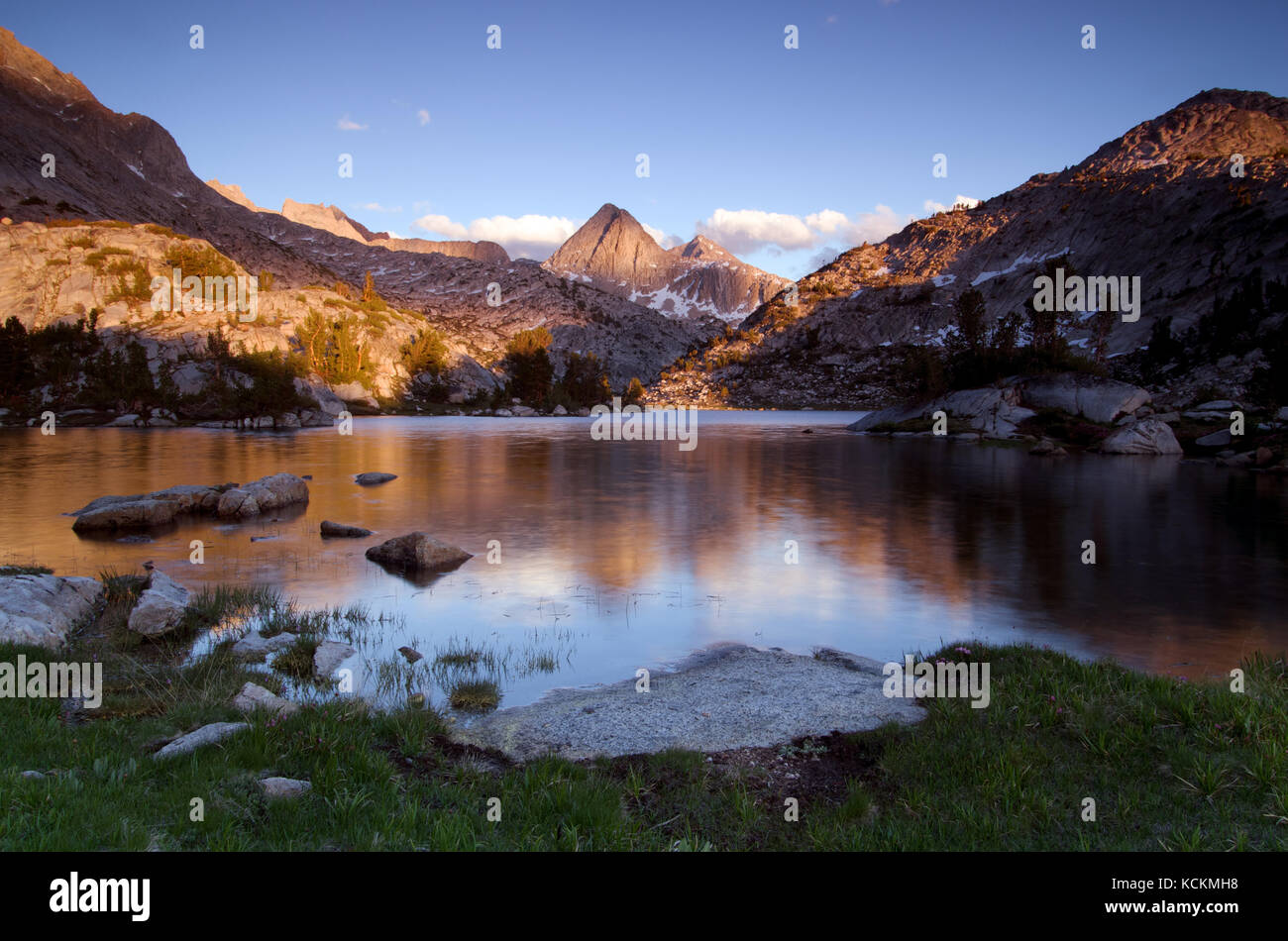 Late afternoon sun on Mount Spencer above Evolution Lake along the John Muir Trail in the Sierra Nevada California Stock Photo