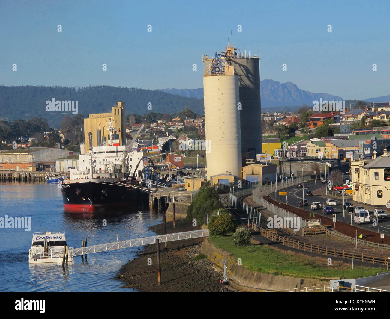 Cement carrier ship being loaded, Mount Roland in the distance. Devonport, Tasmania, Australia Stock Photo