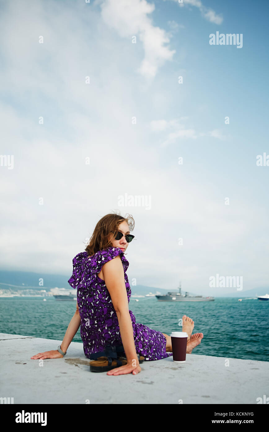 Woman enjoying morning on seafront sunbathing Stock Photo Alamy