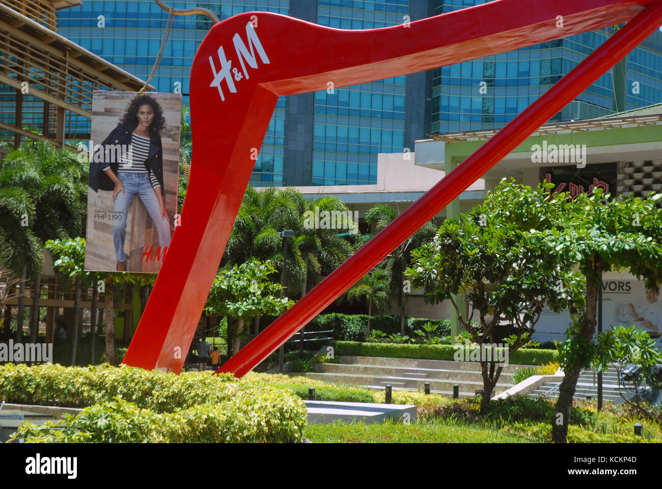 Giant red clothes hanger in the gardens of the Ayala Centre, Cebu City Philippines. Stock Photo