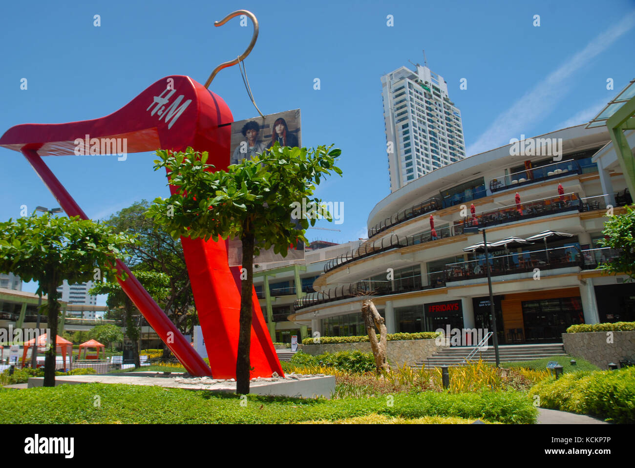 Giant red clothes hanger in the gardens of the Ayala Centre, Cebu City Philippines. Stock Photo