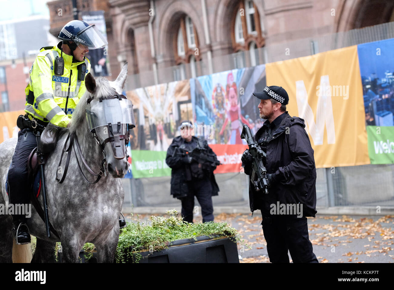 Armed Police officers and mounted officers patrol outside the Midland Hotel in Manchester during the Conservative Party Conference October 2017 Stock Photo