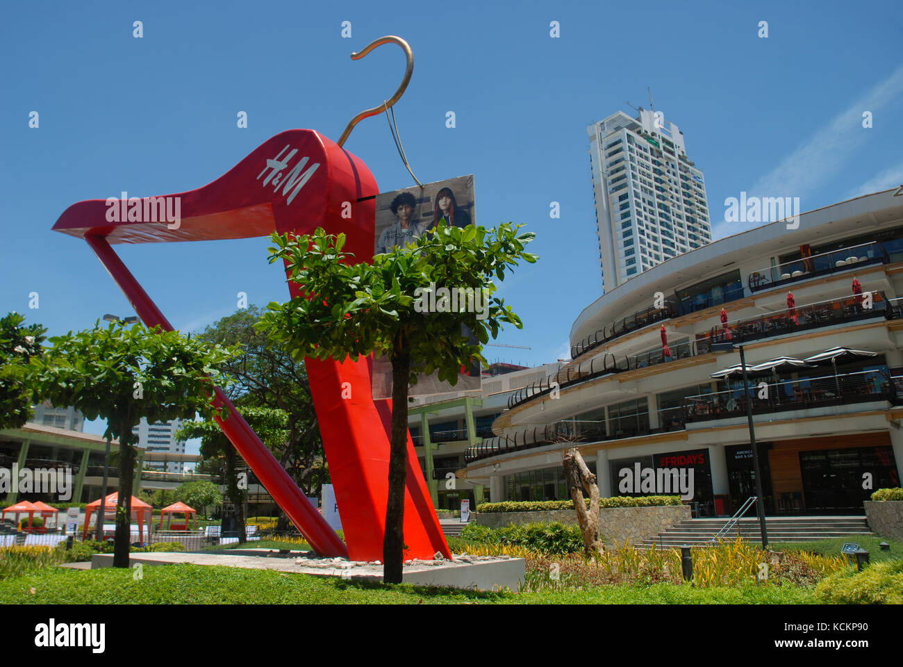 Giant red clothes hanger in the gardens of the Ayala Centre, Cebu City Philippines. Stock Photo