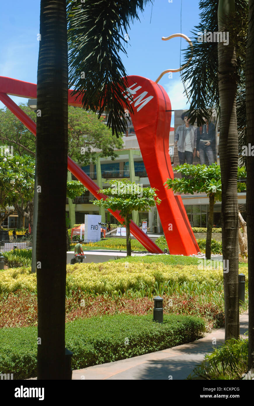 Giant red clothes hanger in the gardens of the Ayala Centre, Cebu City Philippines. Stock Photo