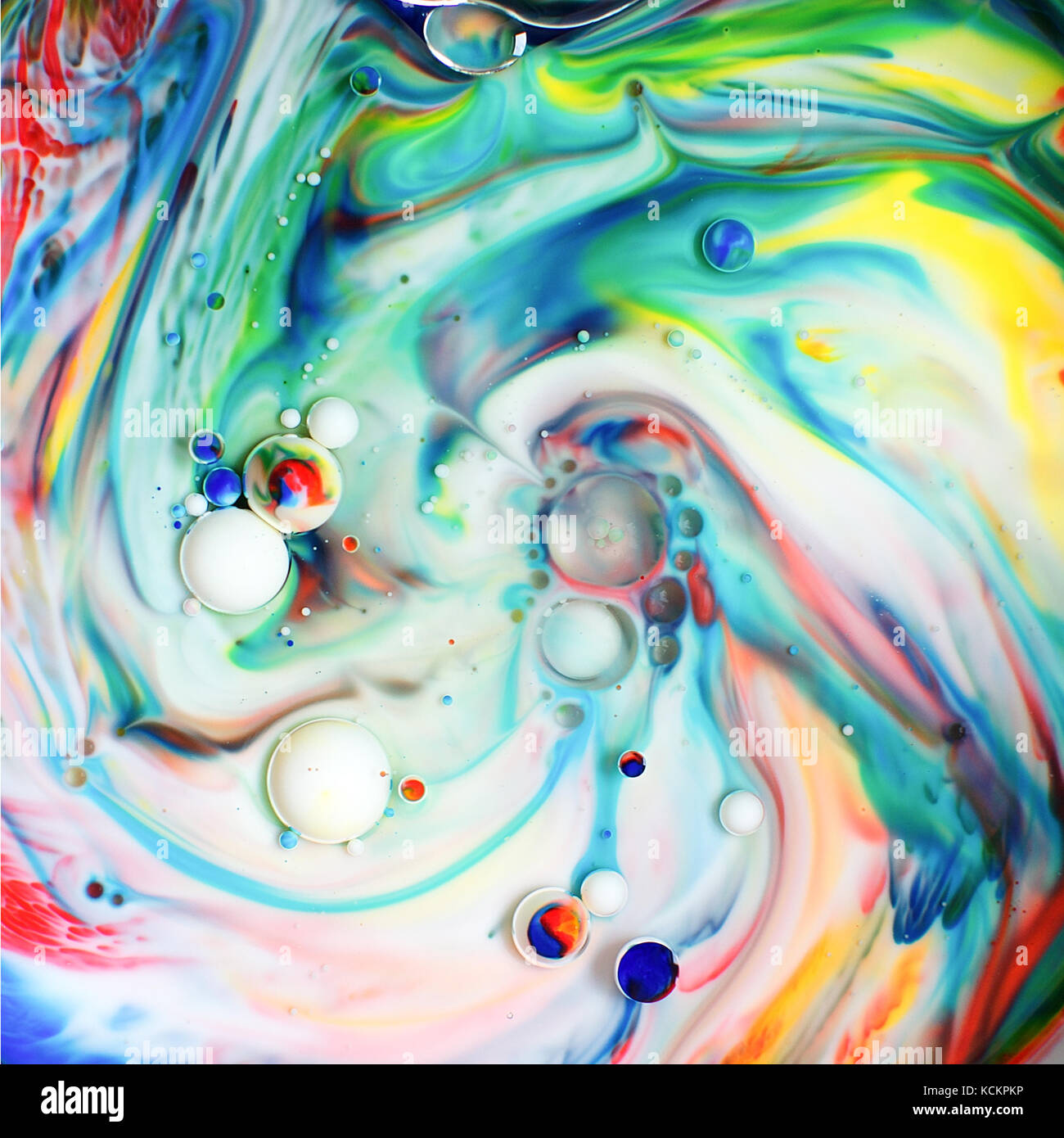 Food colouring poured into milk and oil to give colourful swirls Stock