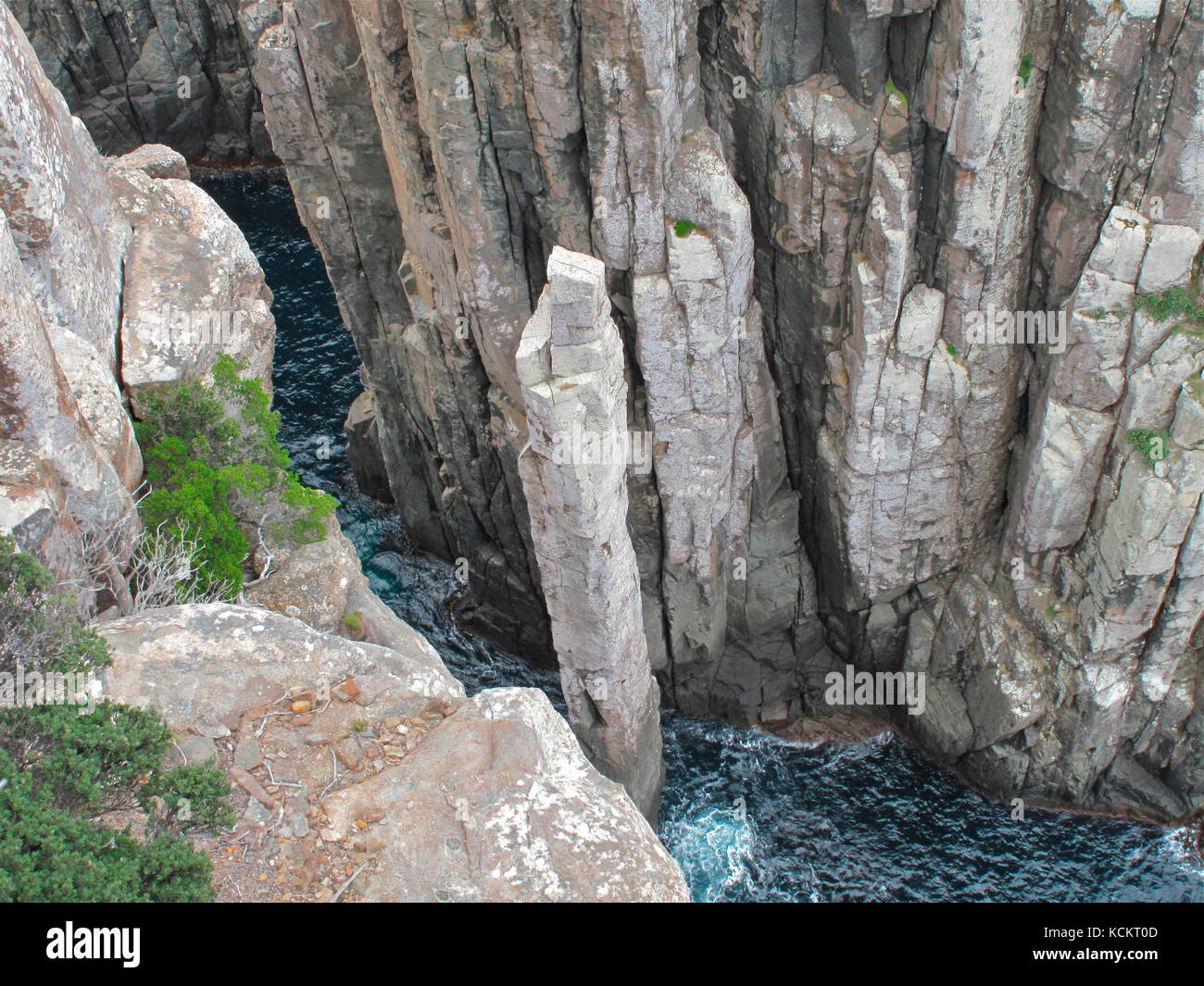 The Totem Pole, about 65 m tall, from above. A columnar dolerite pillar with frequent massive swells crashing around its base. A rockclimbing site, on Stock Photo