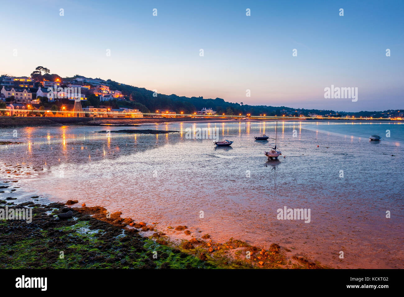 Coastline of Saint Aubin, Jersey, Channel Islands, UK at low tide and sunset Stock Photo