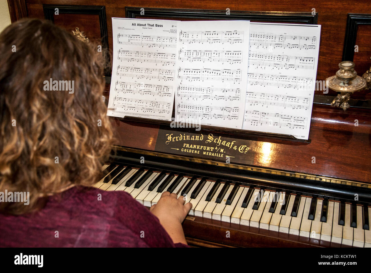 Pianist at an old piano with sheet music and candlesticks Stock Photo