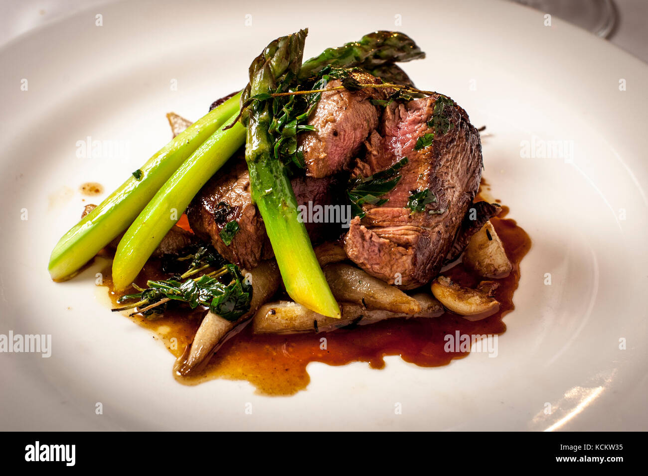 Head chef Paul Wadham serves Longhorn beef fillet with asparagus, Jerusalem artichoke and nut butter in the restaurant at Hotel Tresanton in St Mawes, Cornwall, England. The English Longhorn is a heritage cattle breed prized for its richly flavoured meat. Stock Photo