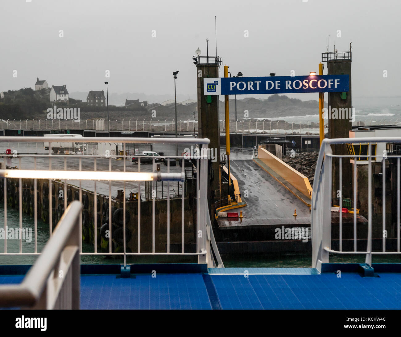 The Armorique on its last meters before the pier in the port of Roscoff. Roscoff Harbor view from Ferry onboard the Armorique Ferry of Brittany Ferries, Roscoff-Morlaix, France - In the mist on the hill you can see the Saint-Barbe chapel. Stock Photo