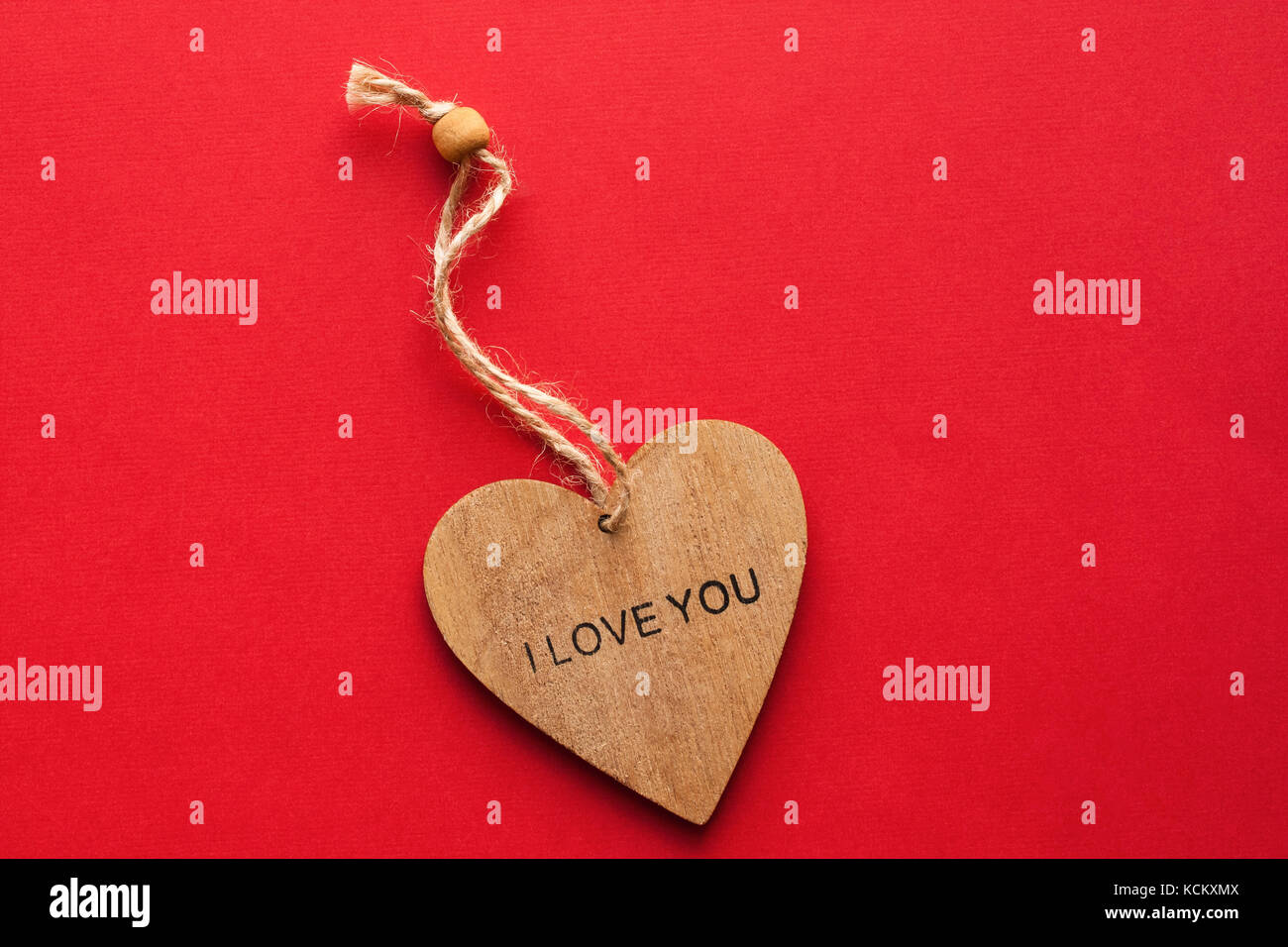 One Wooden Brown Heart With Inscription: "I LOVE YOU" On Red Paper ...