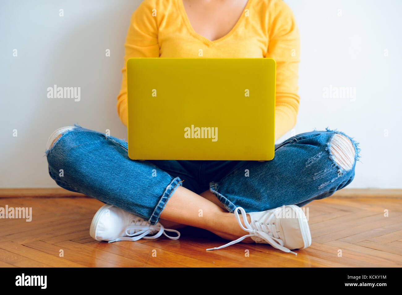 Young pretty woman sitting on the floor with laptop Stock Photo Alamy