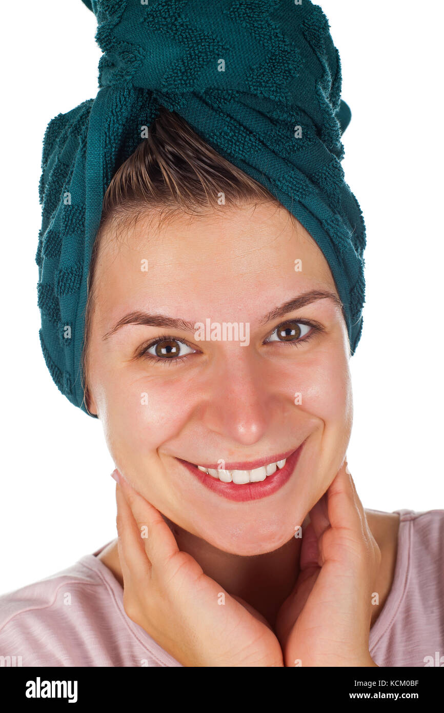 Close up beautiful young female with bath towel on head smiling at the