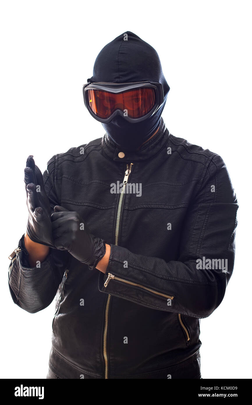 Dangerous burglar dressed in black wearing a mask on head - isolated background Stock Photo