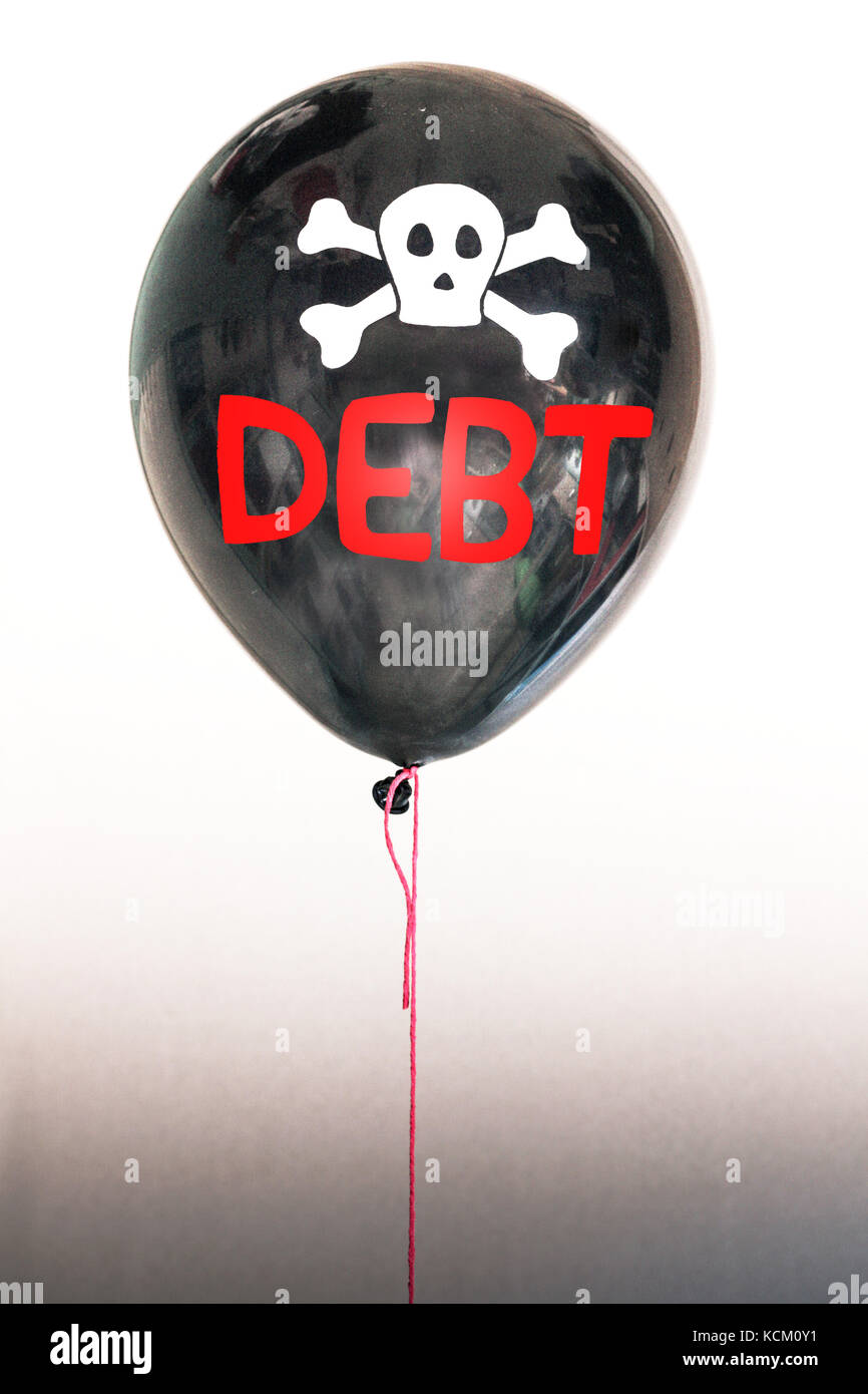 The word debt and a skull and cross bones on a balloon illustrating the concept of a debt bubble, sovereign debt default, US, EU debt. Stock Photo