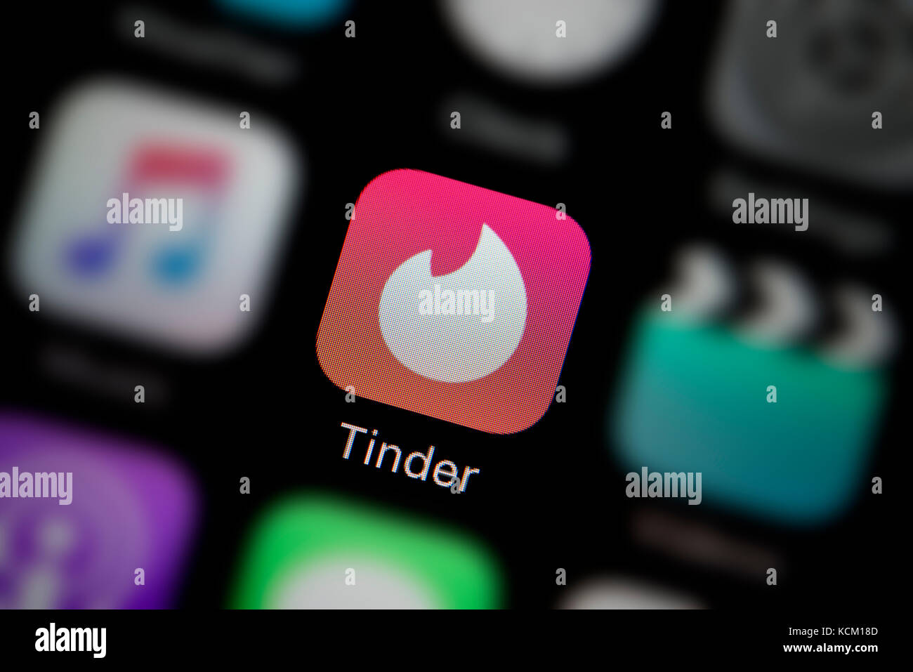 A close-up shot of the company logo representing the Tinder app icon, as seen on the screen of a smart phone (Editorial use only) Stock Photo