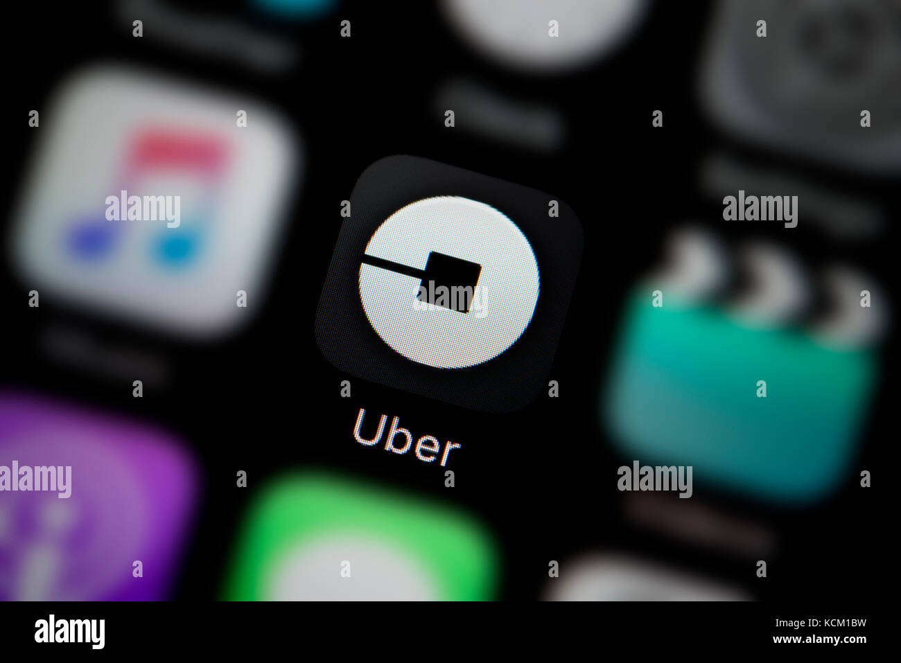 A close-up shot of the company logo representing the Uber app icon, as seen on the screen of a smart phone (Editorial use only) Stock Photo